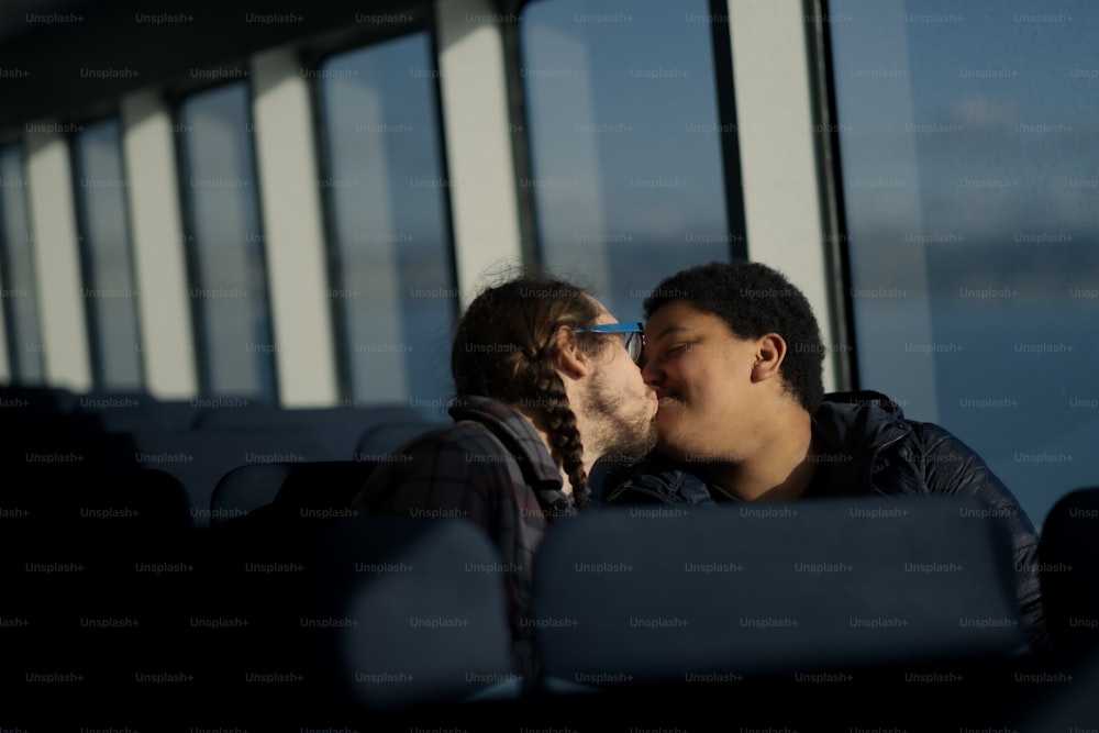 a man and a woman kissing on a bus