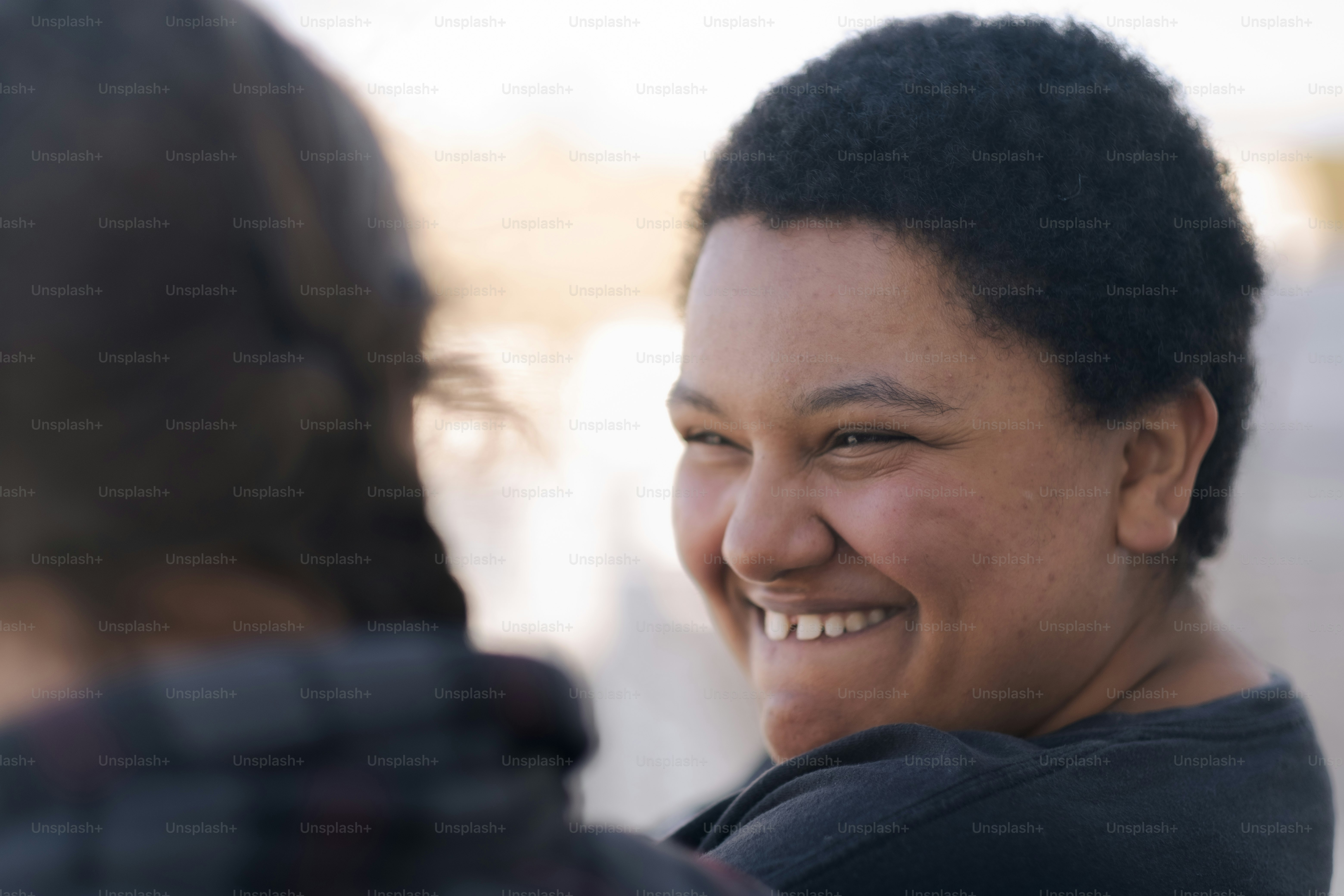 a woman smiles as she talks to another woman
