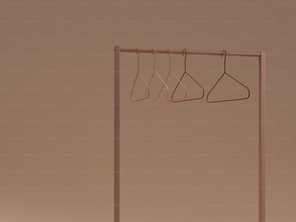 a clothes rack with three hangers on it