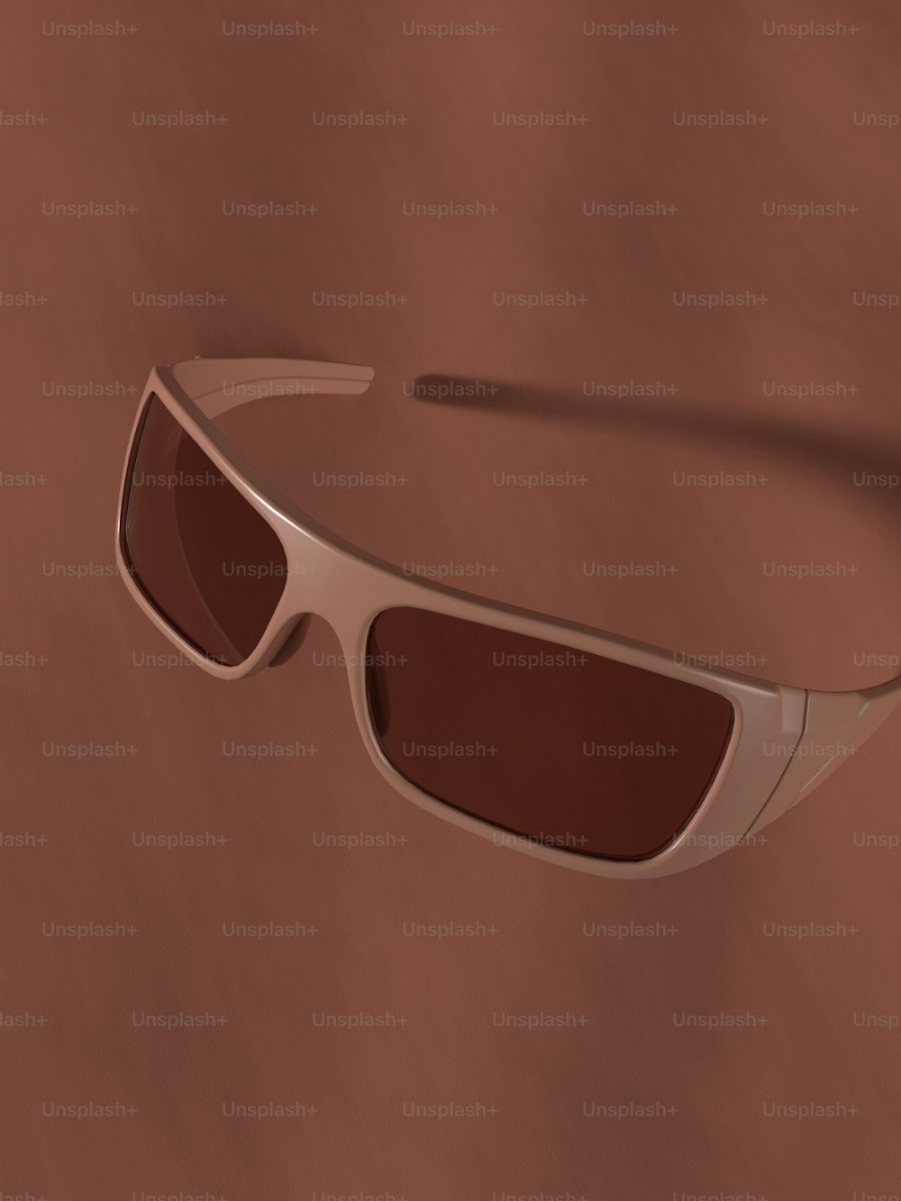a pair of sunglasses on a brown background