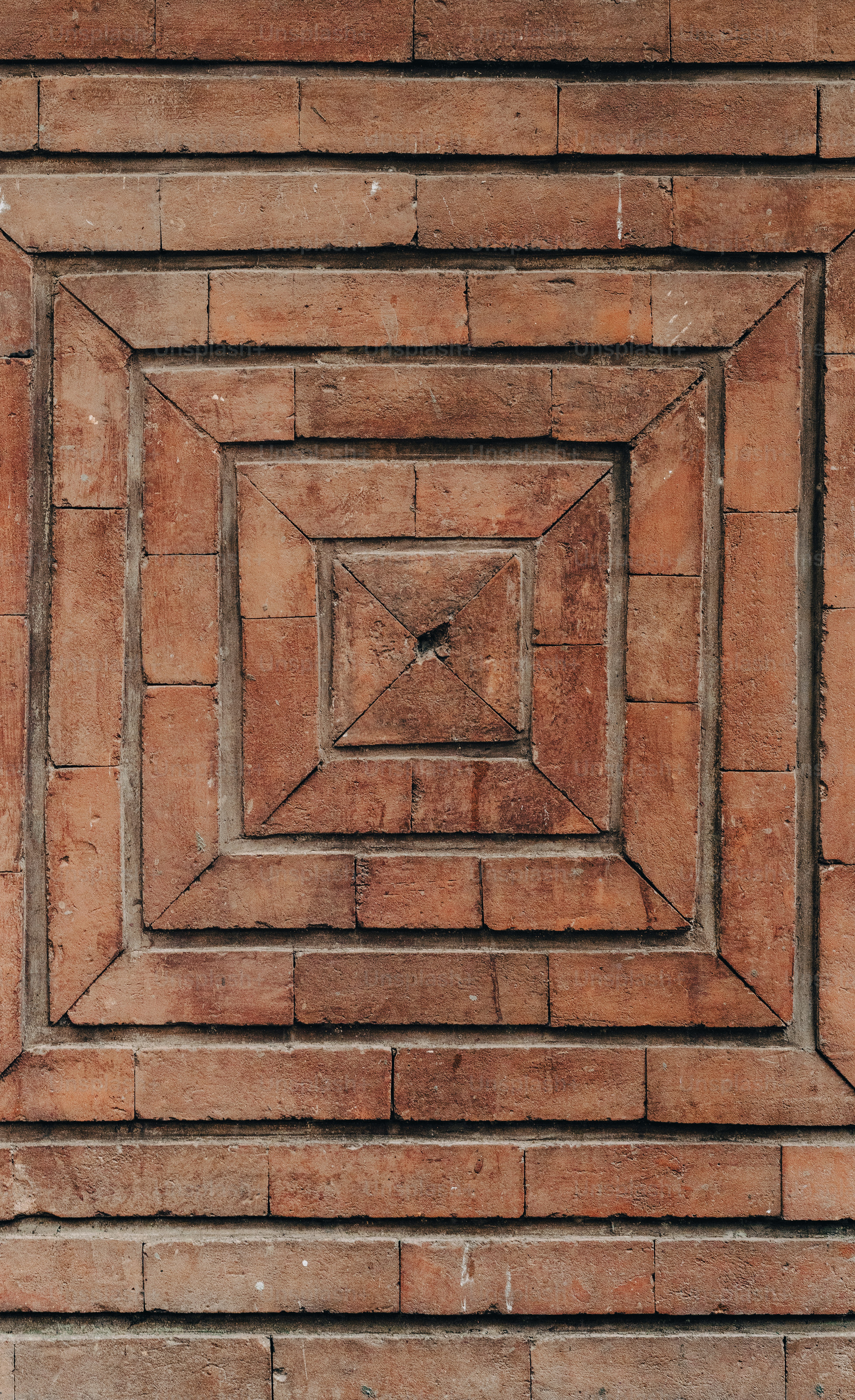a brick wall with a square design in the center