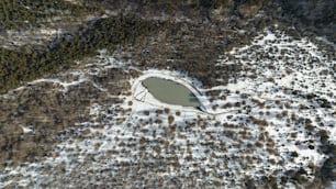 an aerial view of a lake surrounded by snow