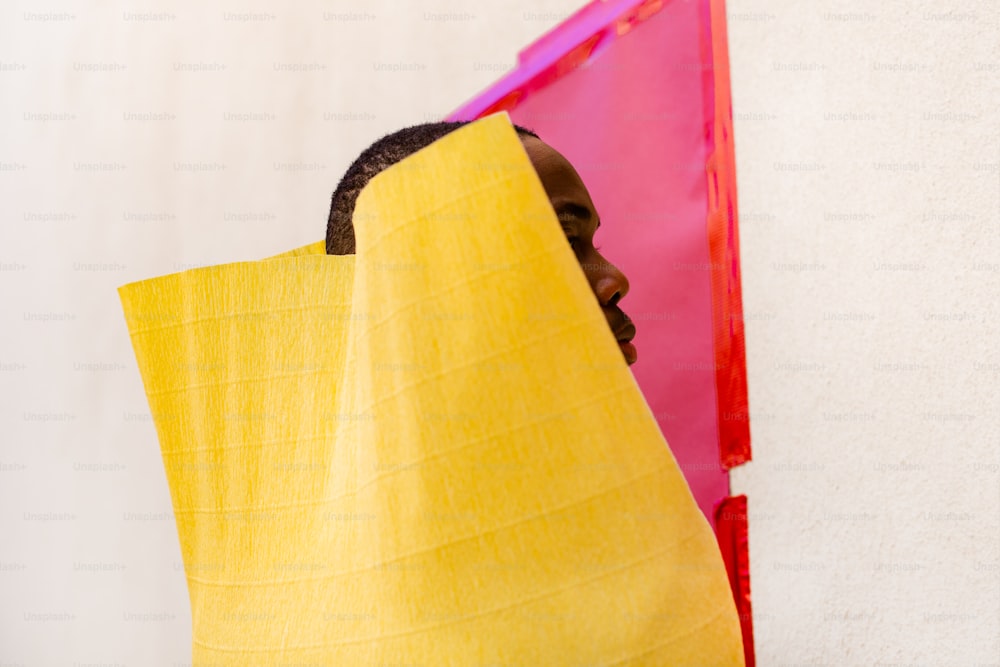 a man wrapped in a yellow towel