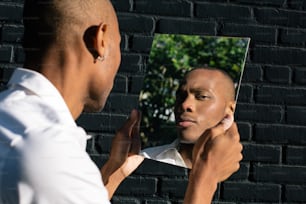 a man looking at his reflection in a mirror