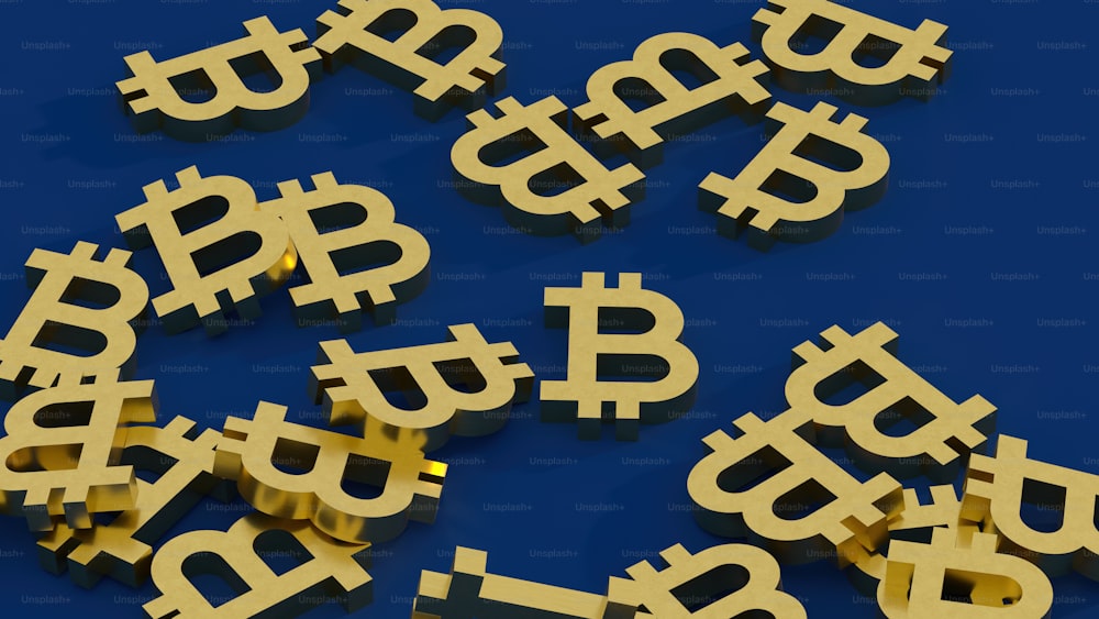 a pile of golden bitcoins sitting on top of a blue surface