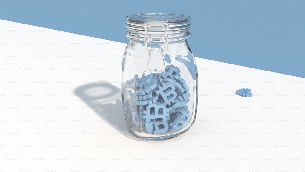 a jar filled with blue letters sitting on top of a table