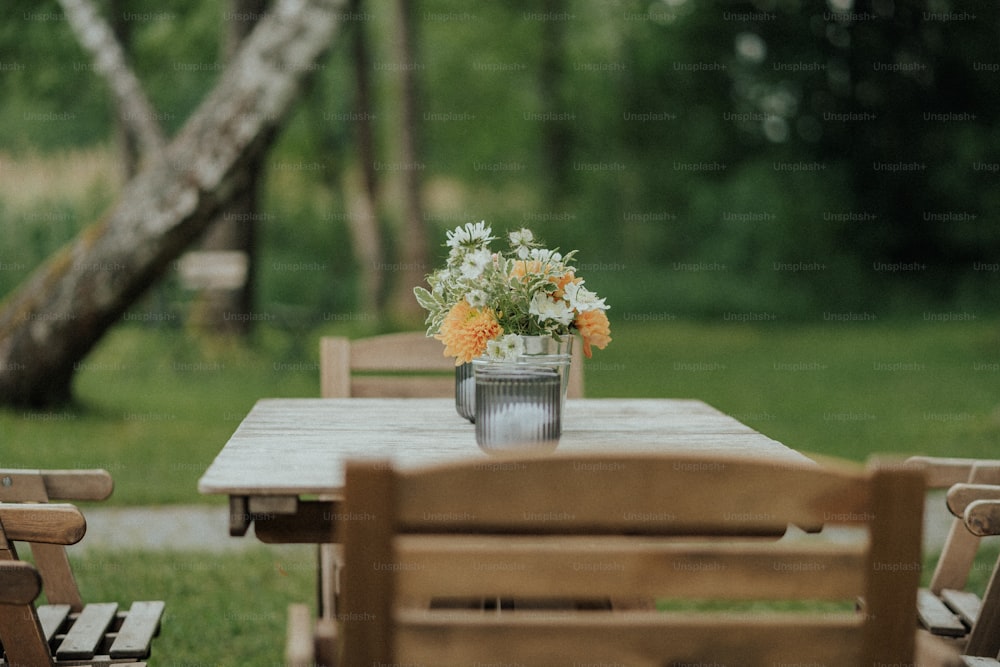 a wooden table with a vase of flowers on top of it