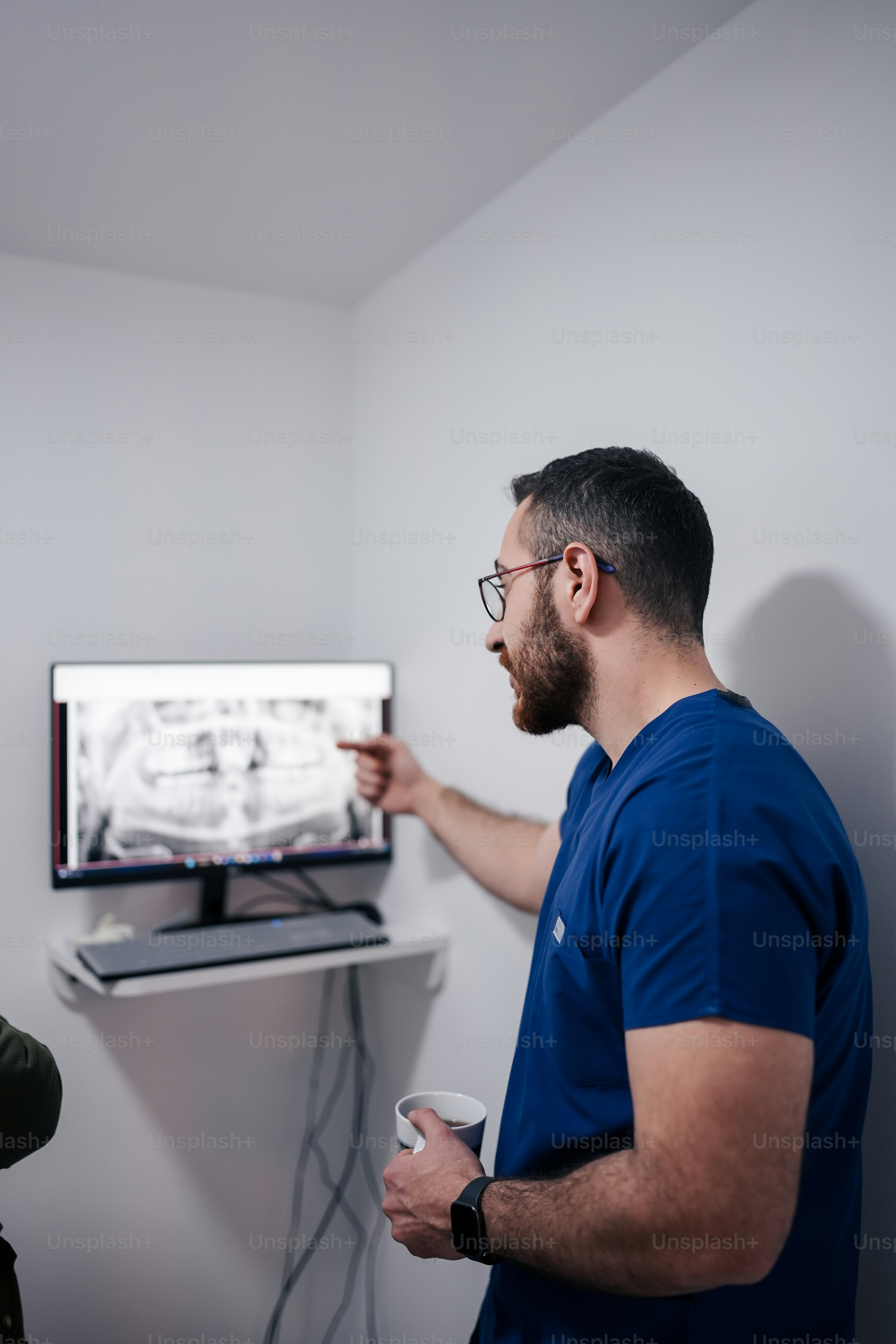 a man standing in front of a flat screen tv