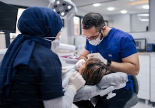 a woman getting her teeth checked by a dentist