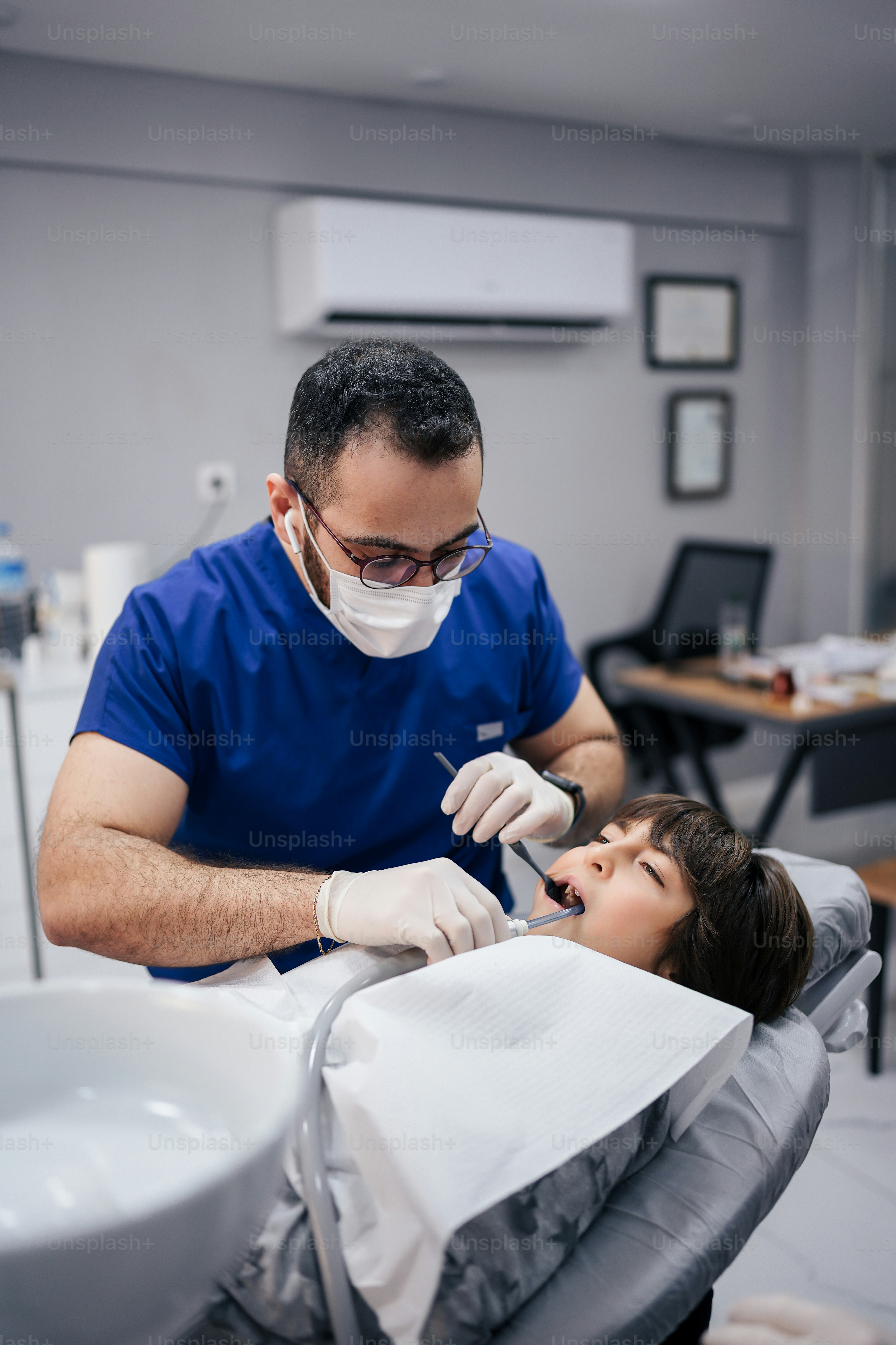 A man getting his teeth checked by a dentist photo – Dentist Image on ...
