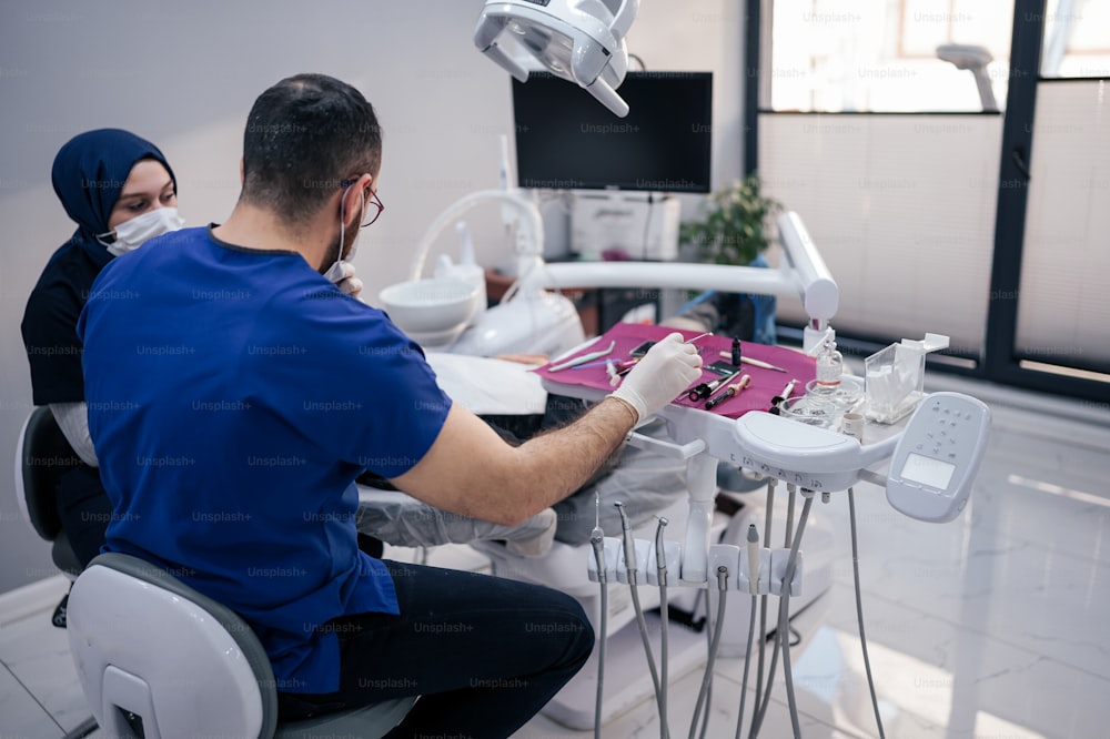 a man and a woman sitting at a table in a dental office