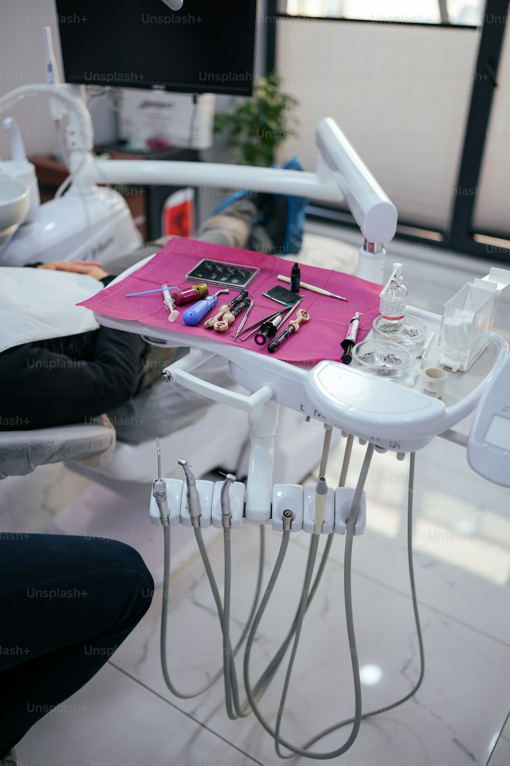 a dentist's chair with a tray of tools on it