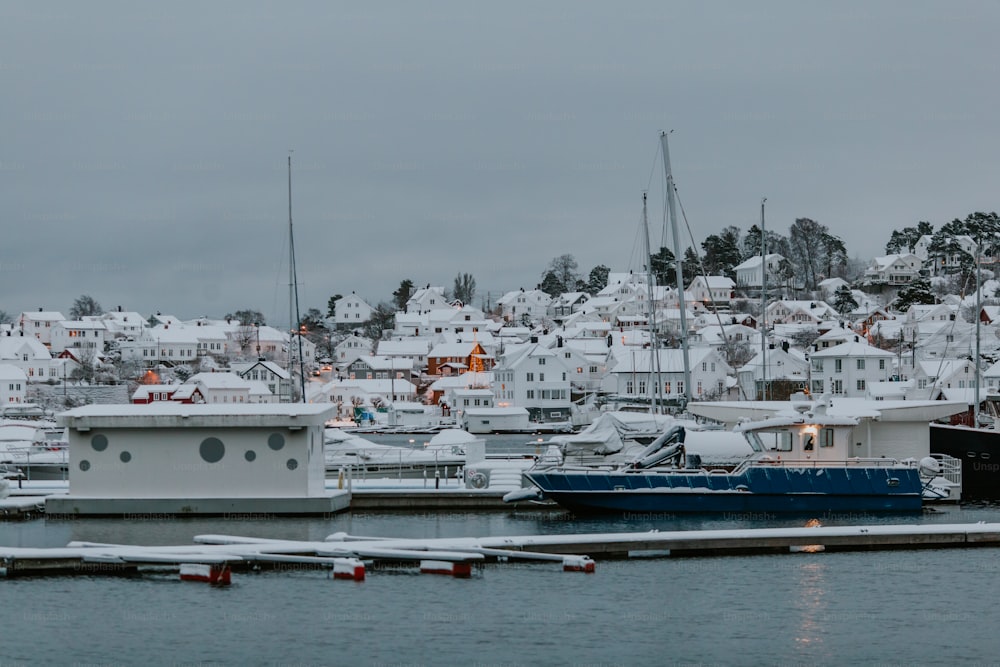 a harbor filled with lots of boats covered in snow