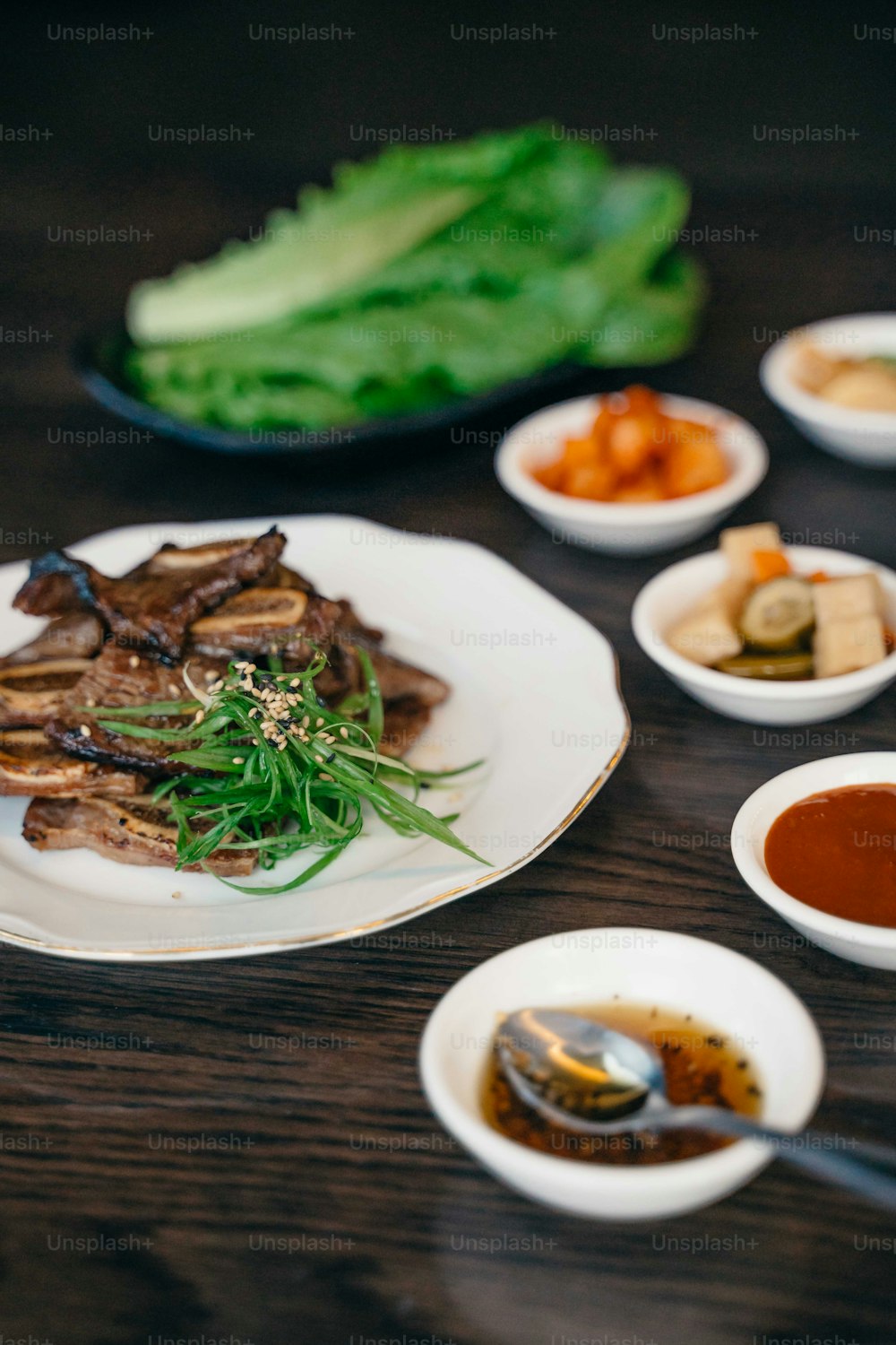 a wooden table topped with plates of food