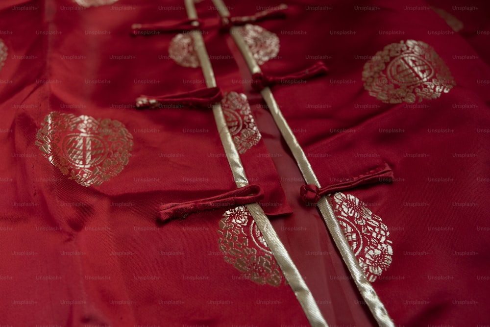 a red cloth with gold designs on it