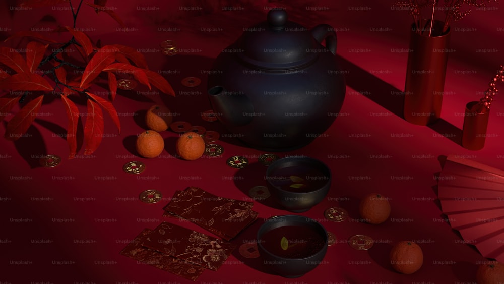 una tetera, una taza de té y algunas naranjas en una mesa