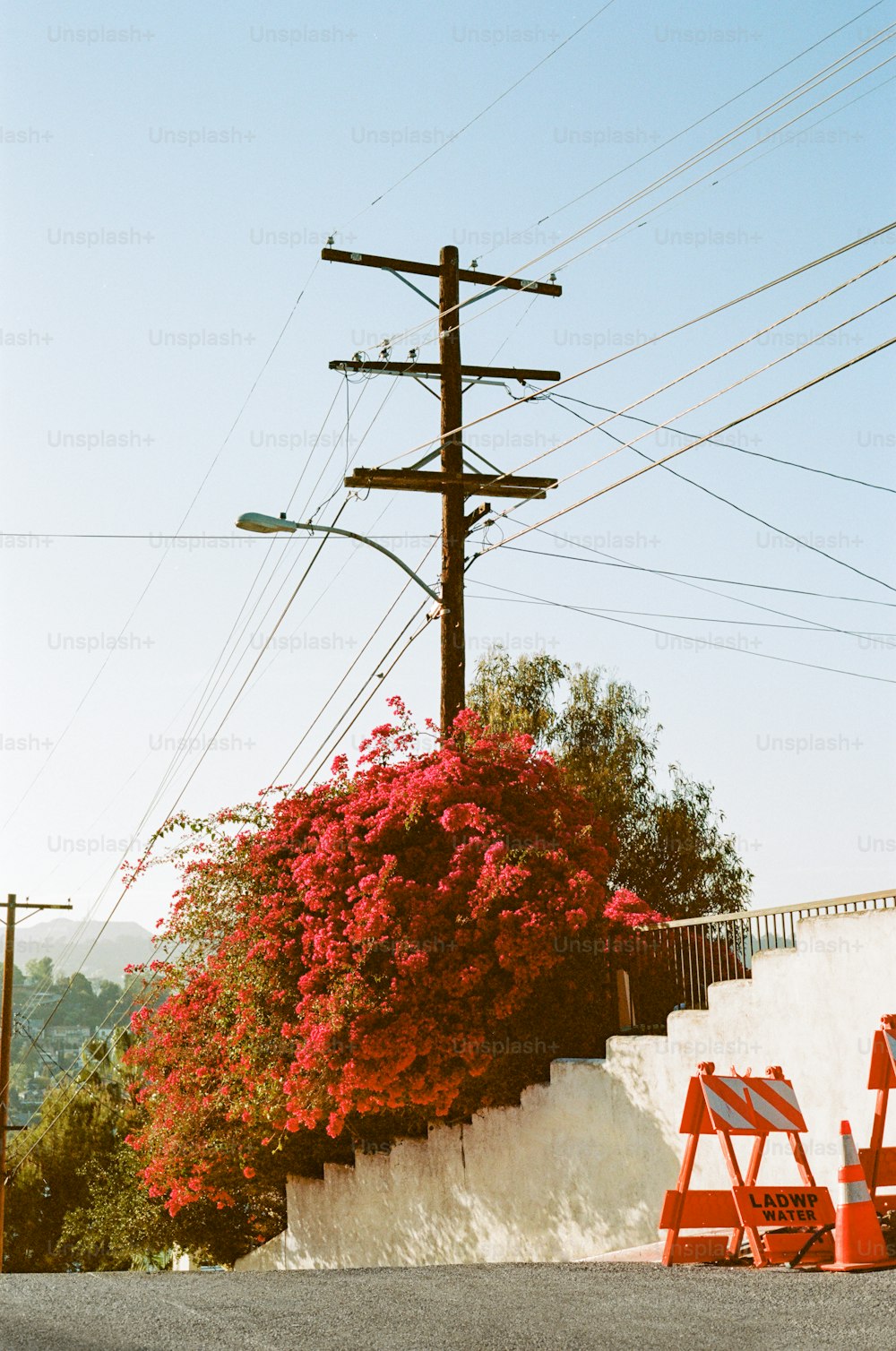 a couple of red chairs sitting under power lines