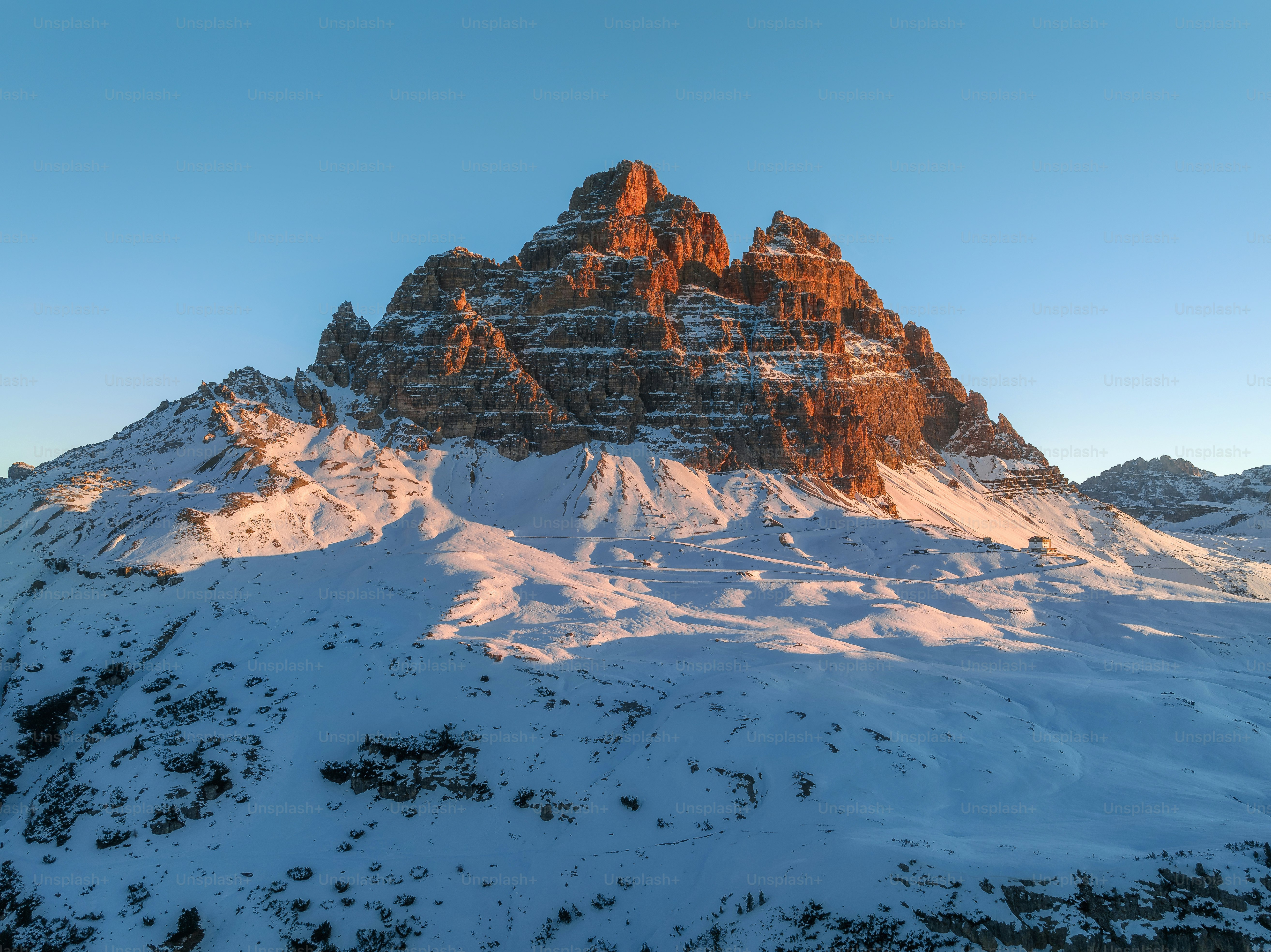 a mountain covered in snow under a blue sky