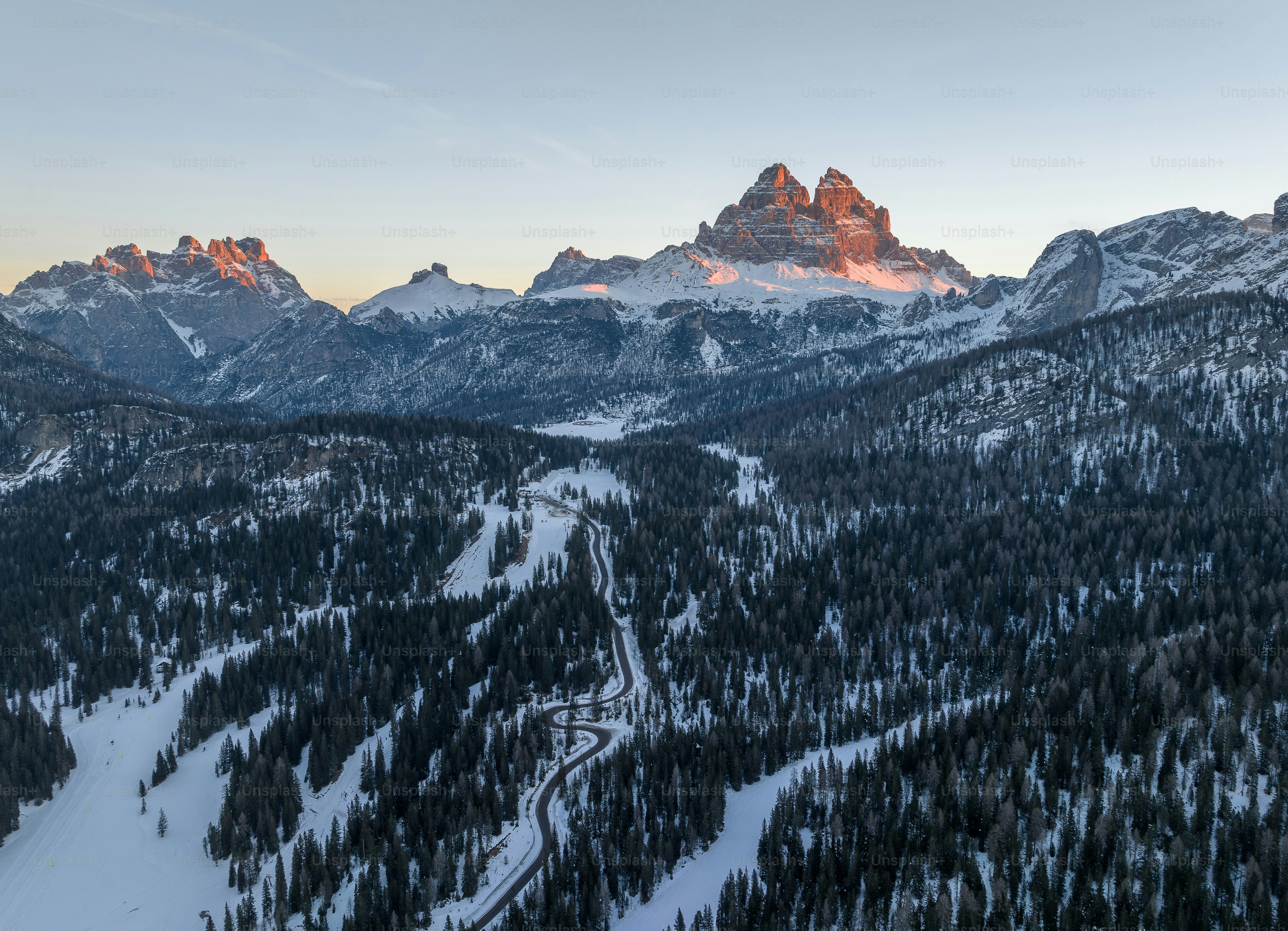 a view of a mountain range with trees and mountains in the background