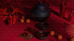 una tetera, una taza de té y naranjas sobre un fondo rojo