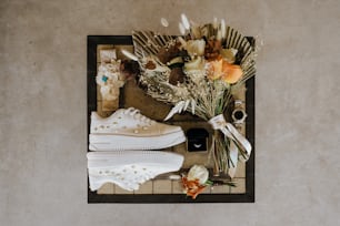 a pair of white sneakers sitting on top of a table