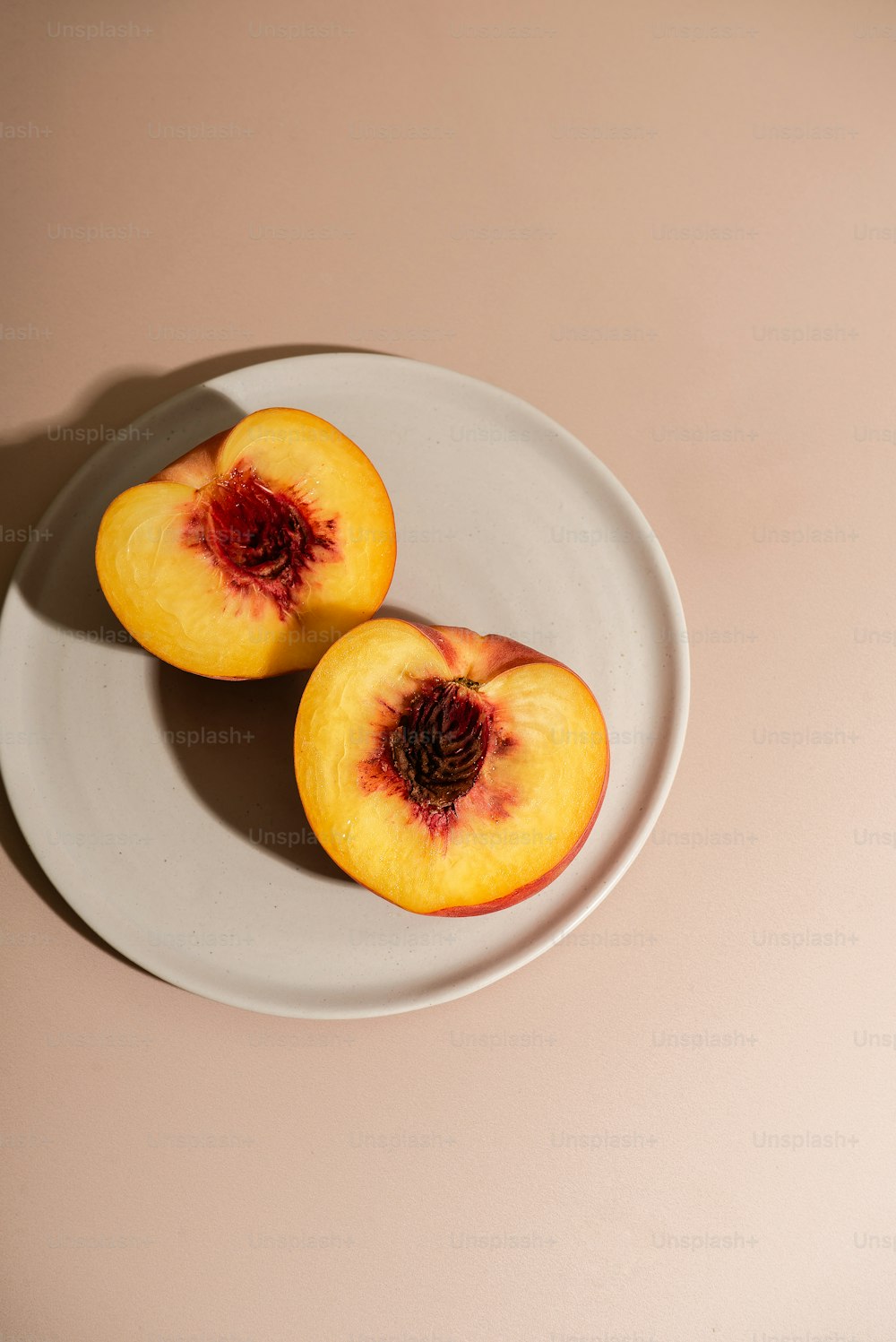 a white plate topped with two pieces of fruit