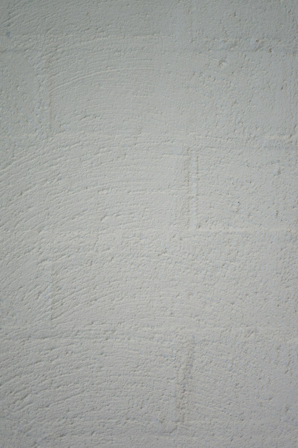 a black and white photo of a white wall
