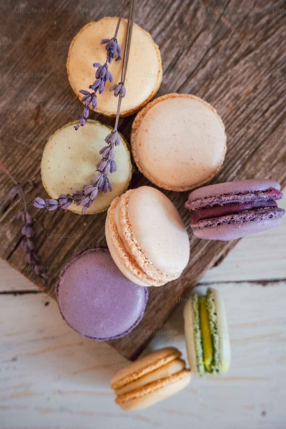a wooden board topped with different types of macaroons