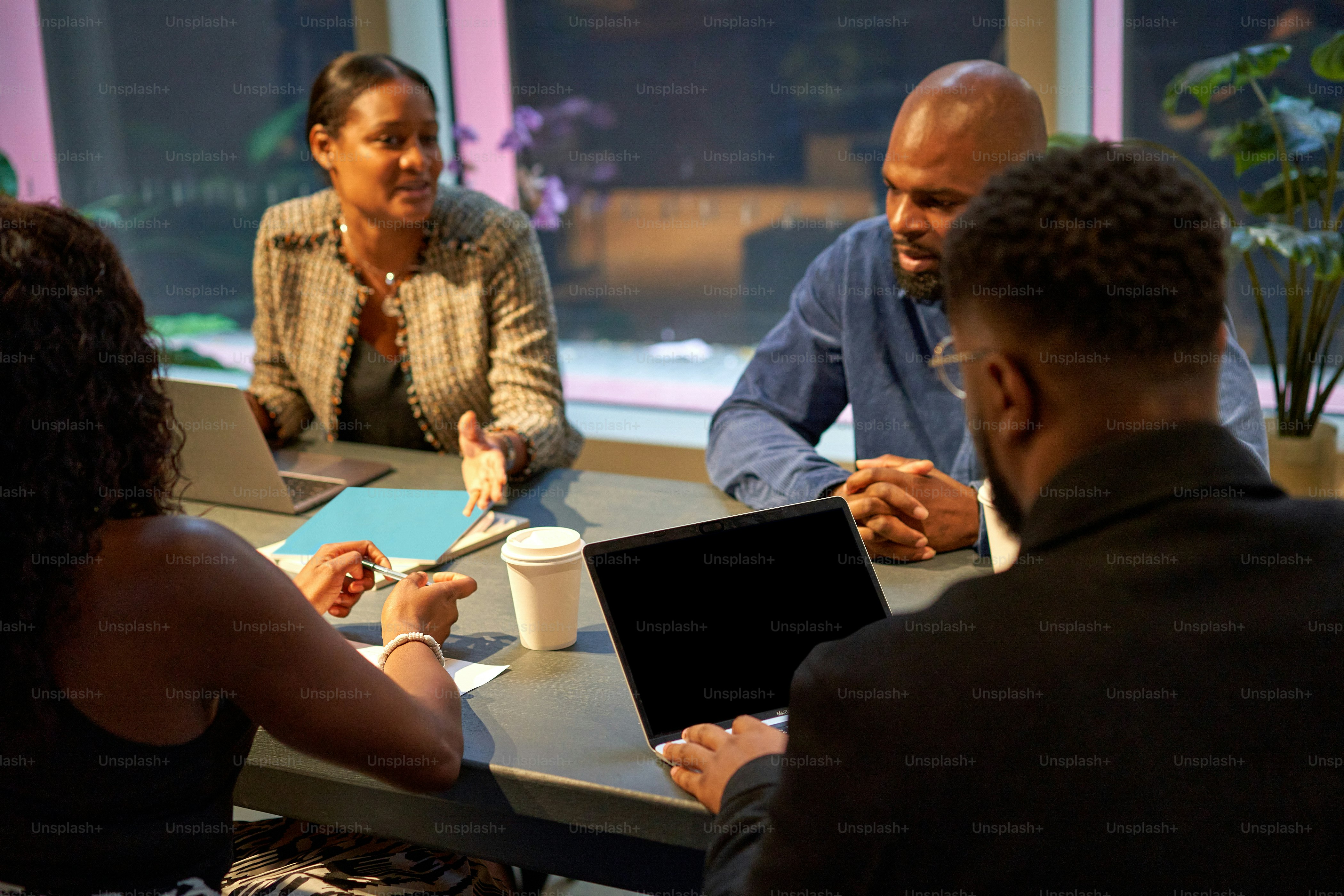 a group of people sitting around a table