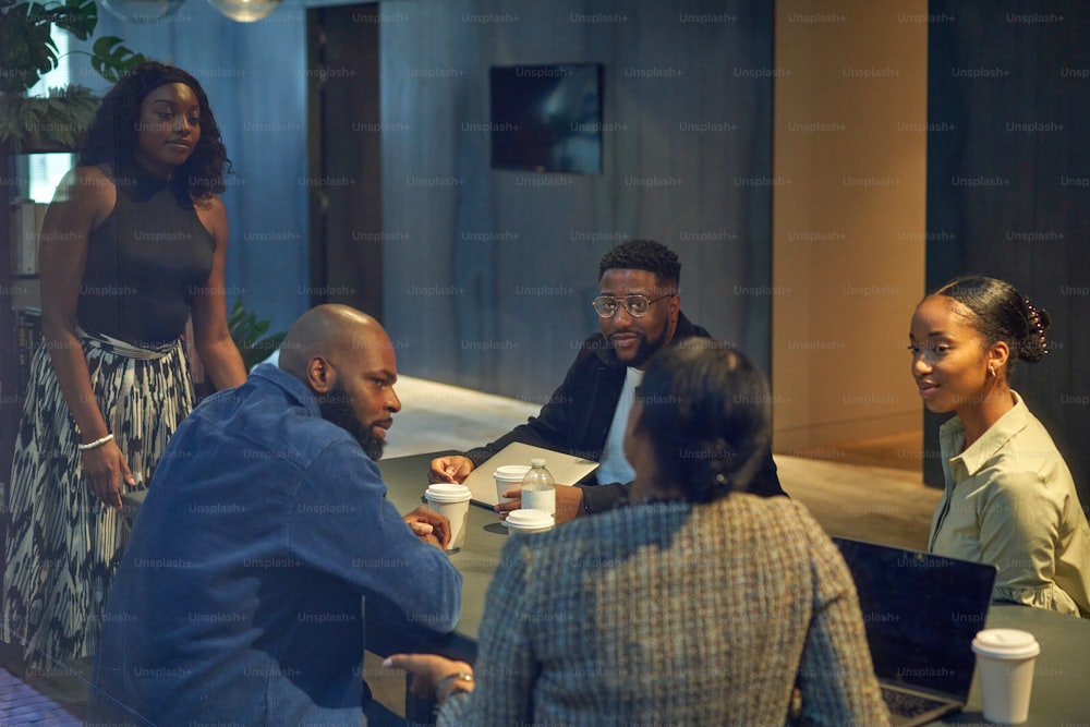 a group of people sitting around a table