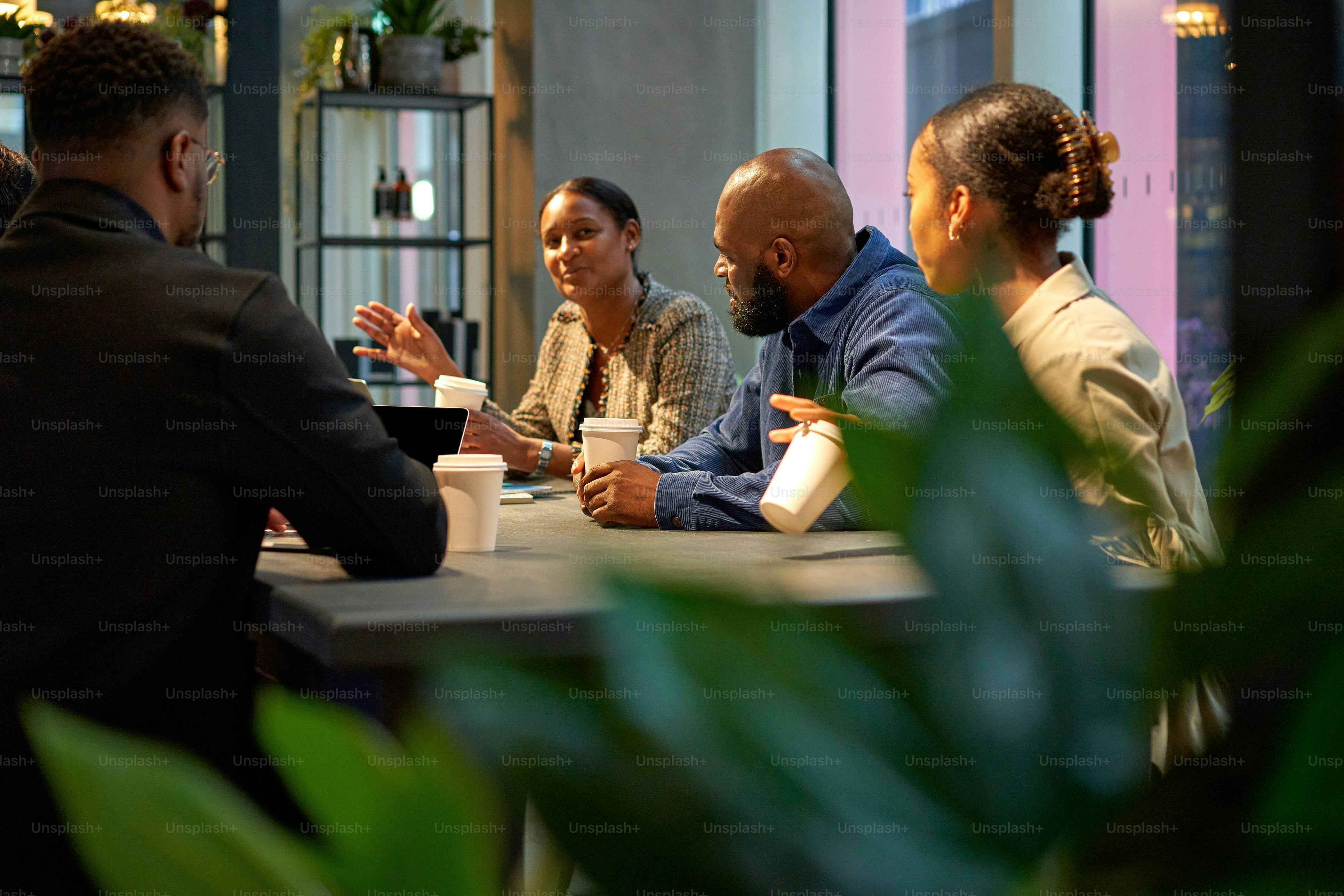 Un grupo de personas sentadas alrededor de una mesa hablando