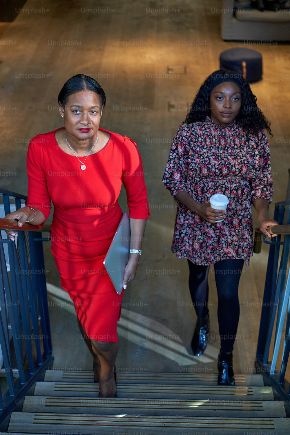 two women walking down a flight of stairs