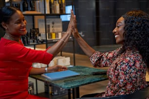 two women giving each other a high five