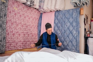 a woman sitting on a bed in a room