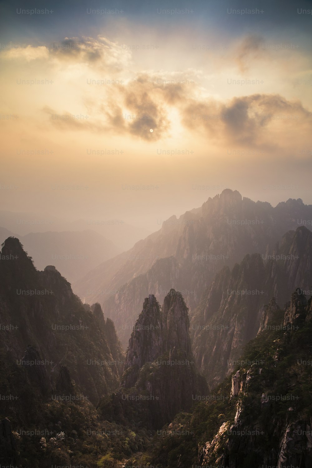 the sun is setting over a mountain range