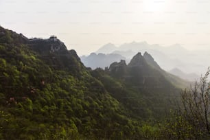 a view of a mountain range with trees and mountains in the background