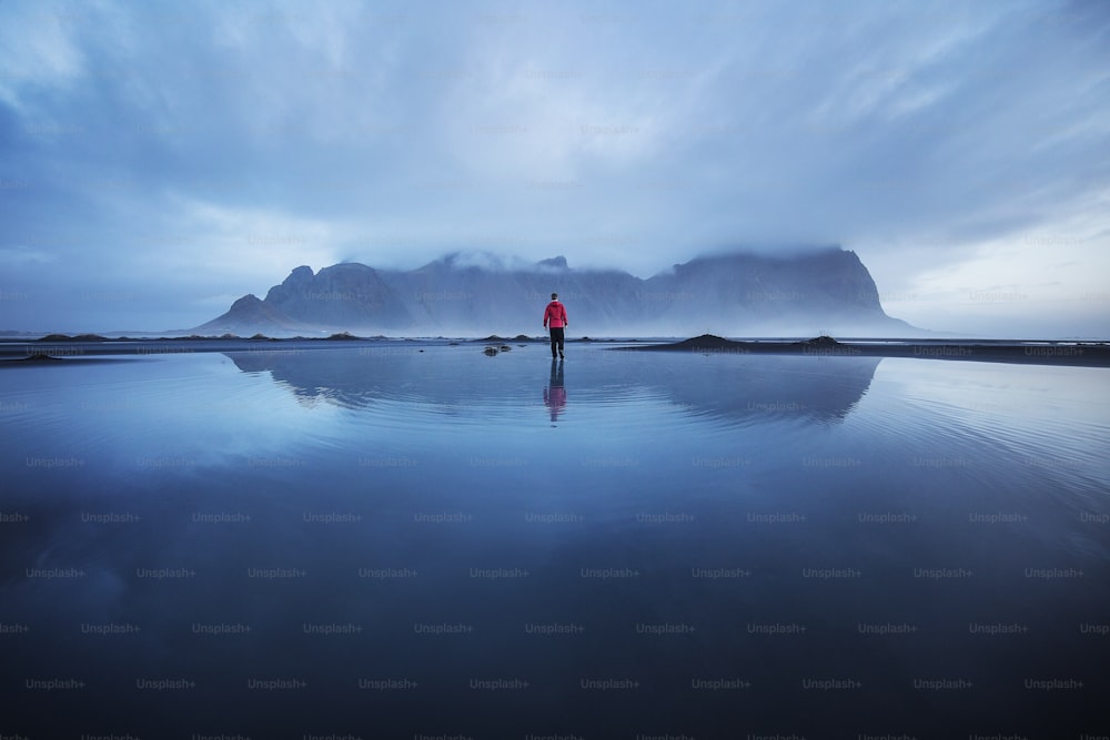 a person standing in the middle of a body of water