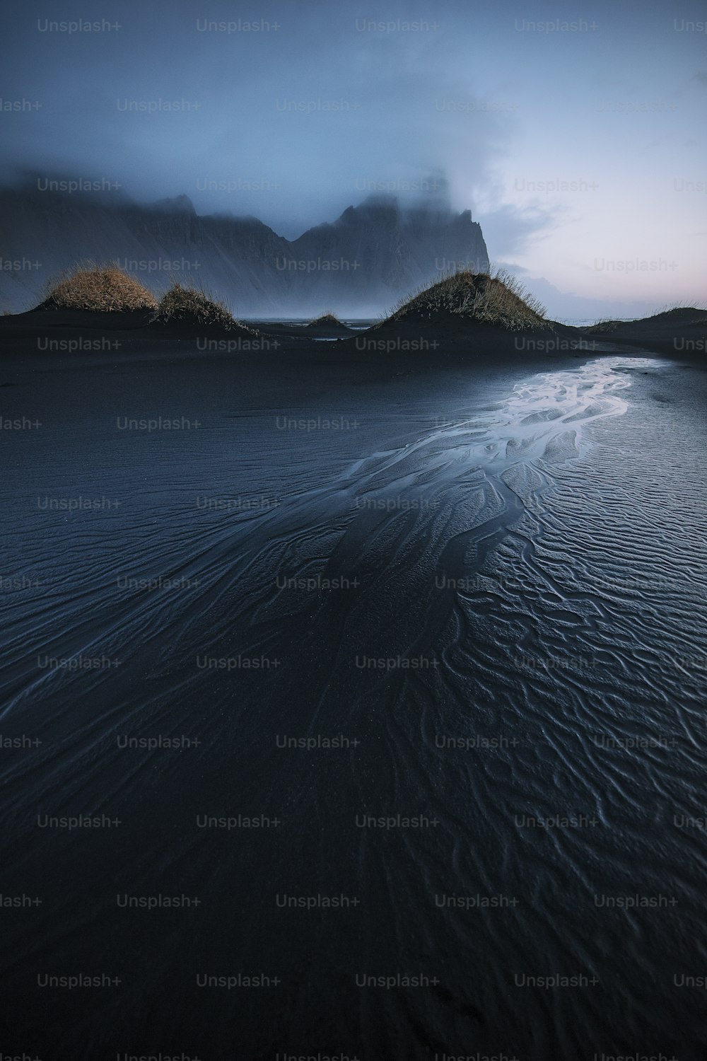 a beach with a mountain in the background