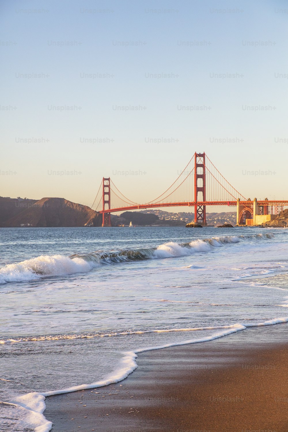 a view of the golden gate bridge from the beach