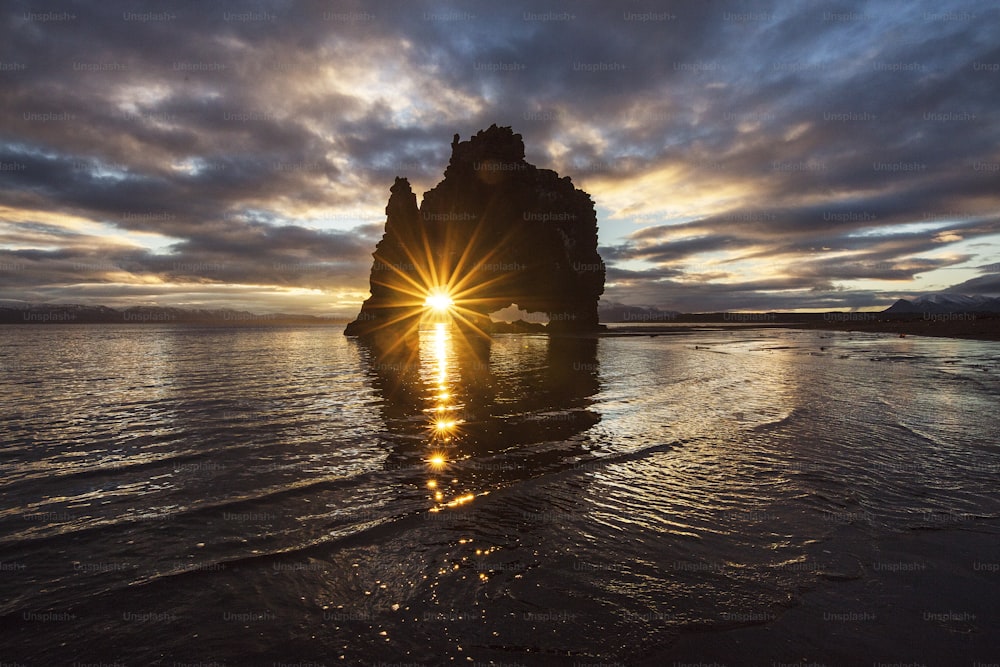 the sun shines brightly through the clouds over the ocean