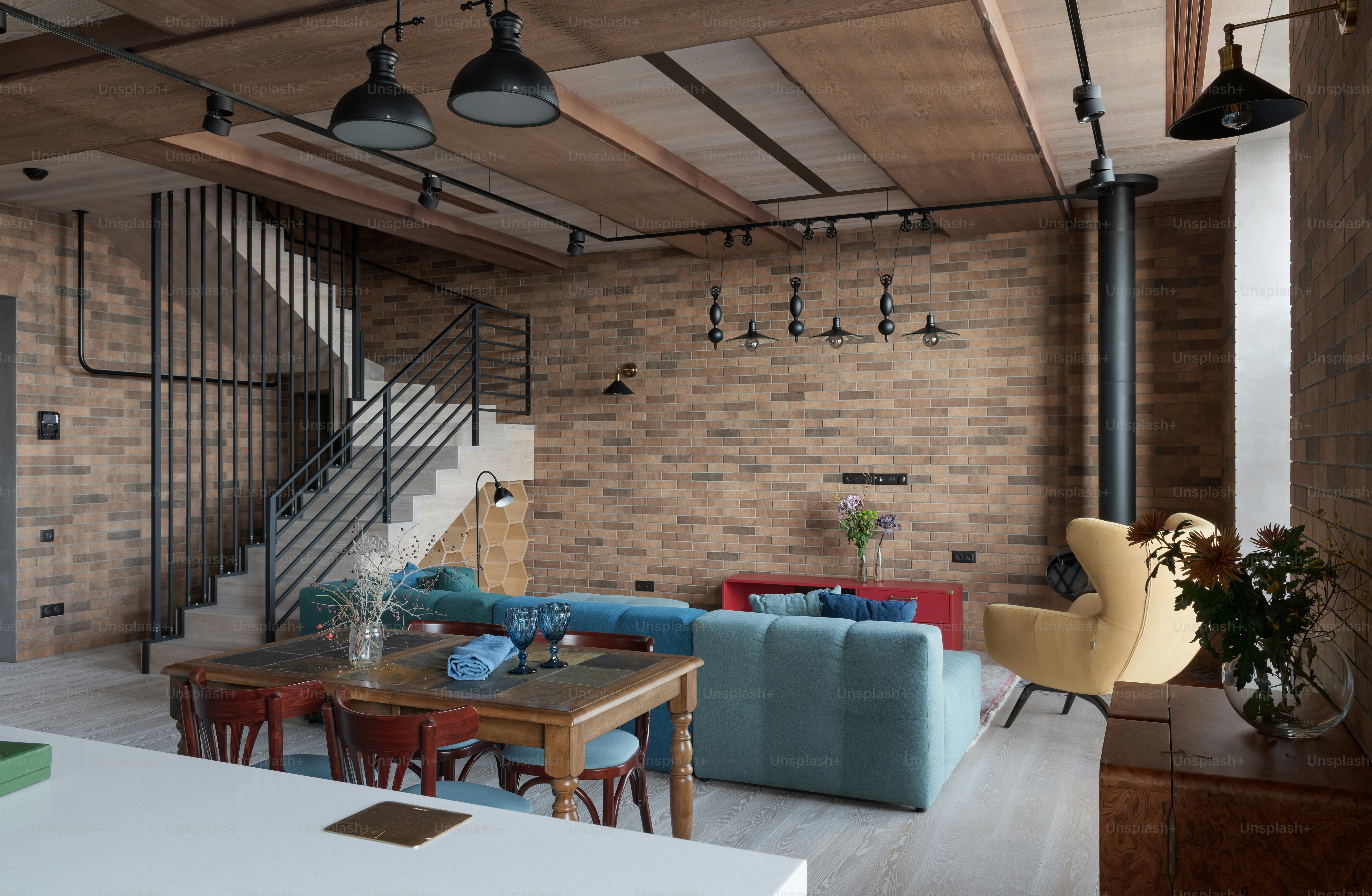 A living room filled with furniture and a staircase photo – Home design