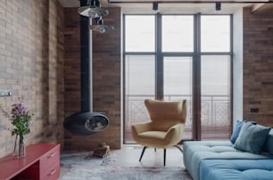 a living room with a blue couch and a chair