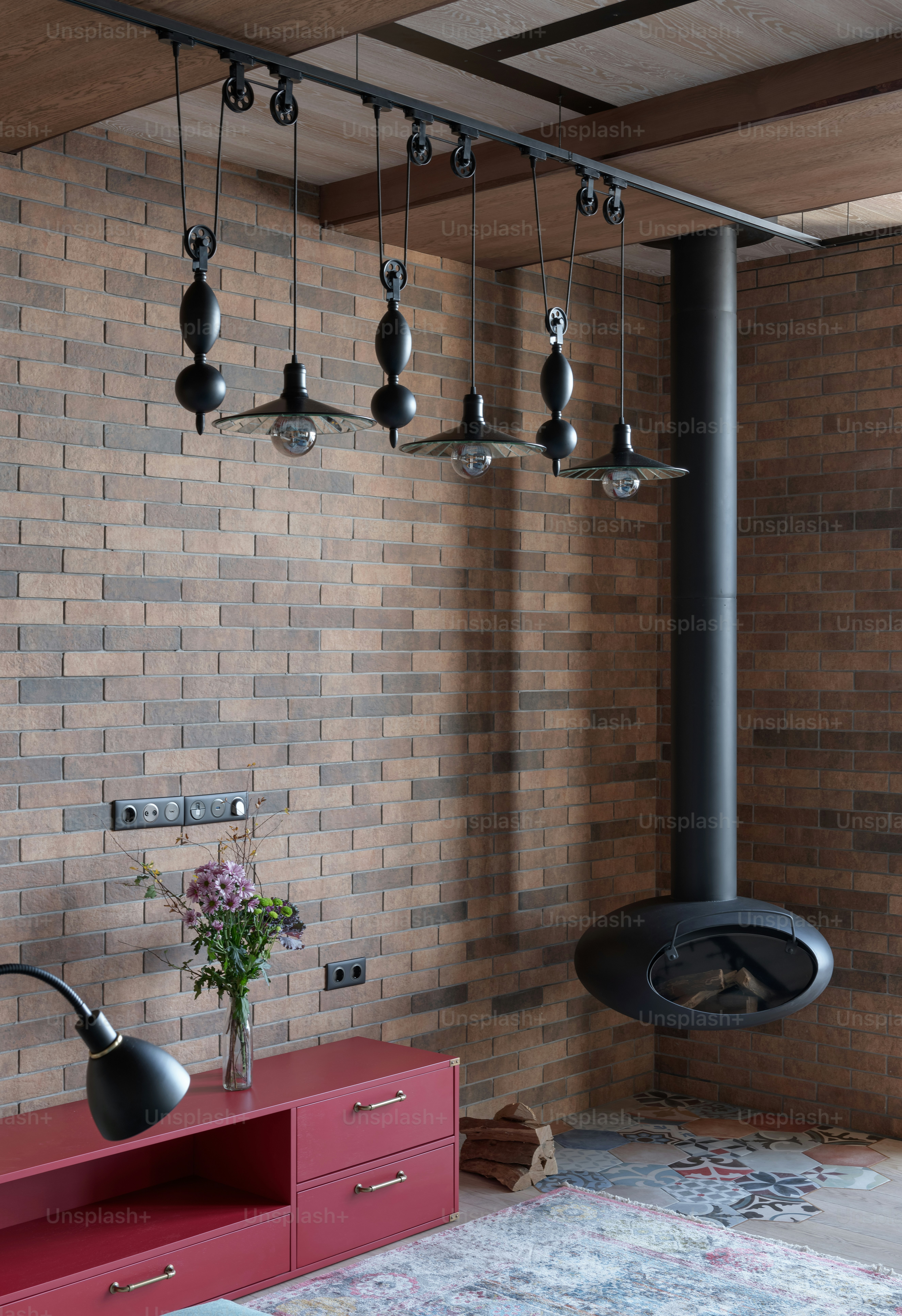 a room with a red cabinet and a brick wall