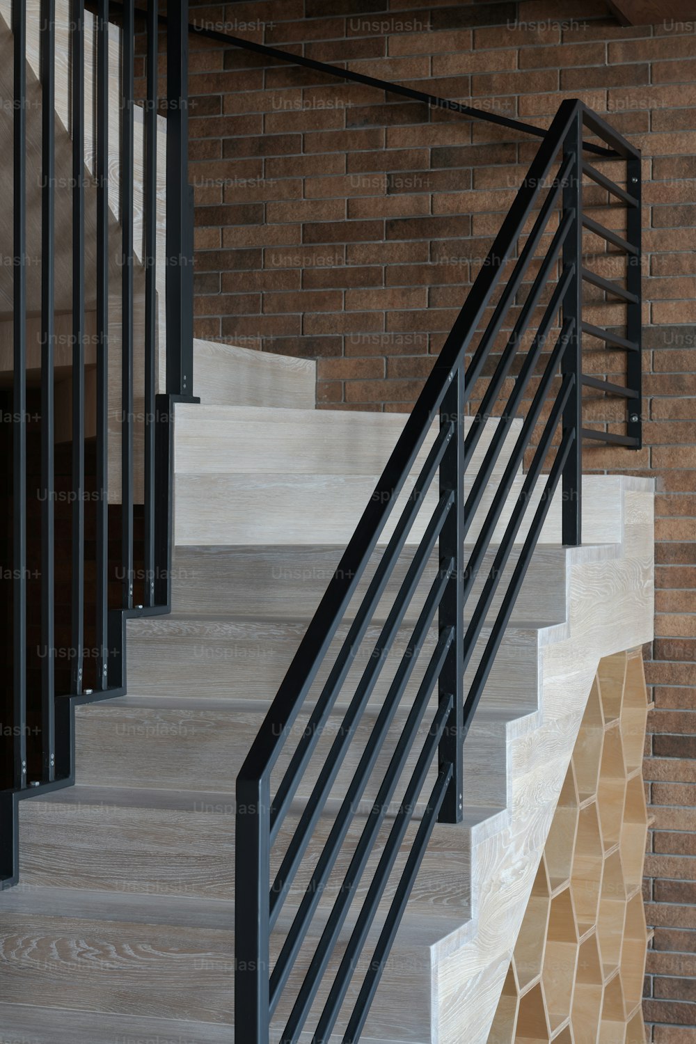 a set of stairs next to a brick wall