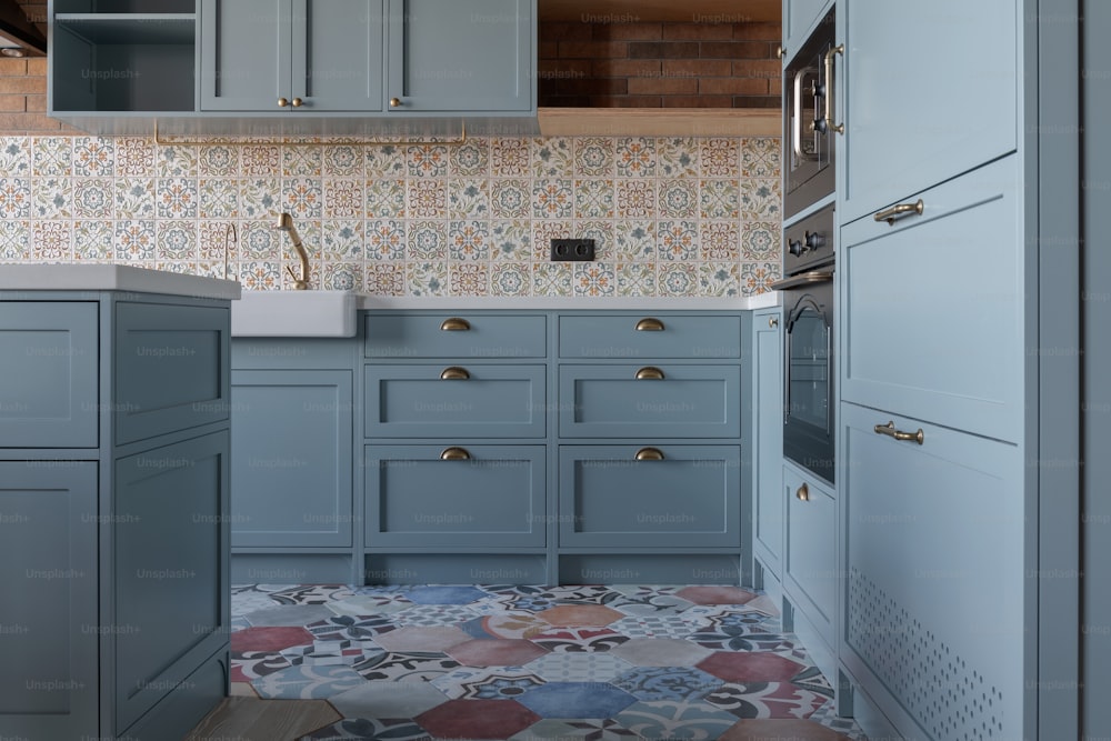 a kitchen with blue cabinets and a tiled floor