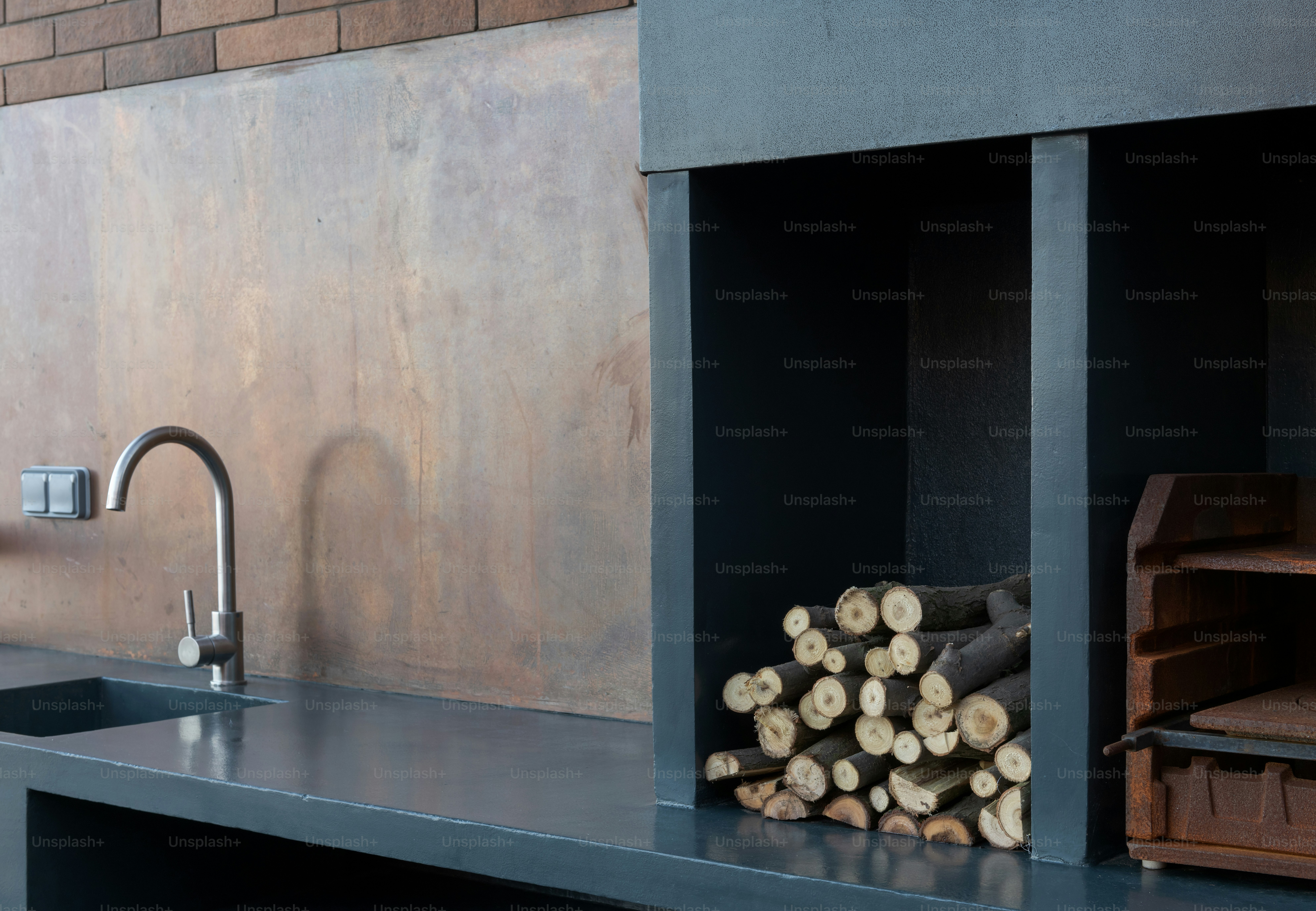 a kitchen with a sink and a bunch of logs