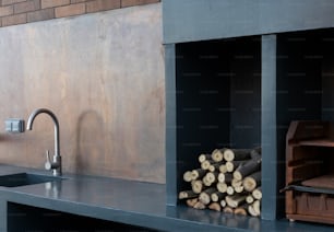 a kitchen with a sink and a bunch of logs