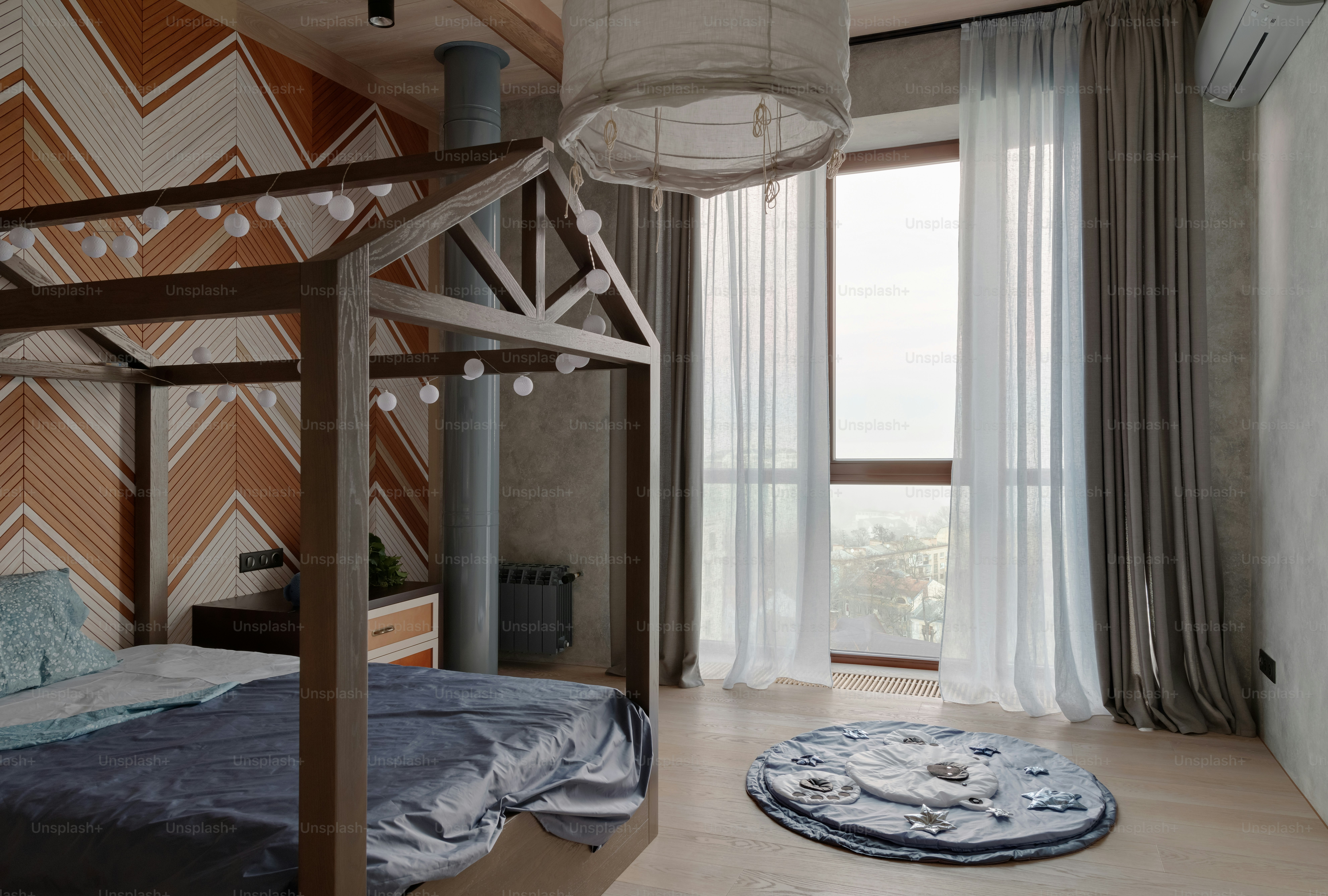 a bedroom with a bed and a large window