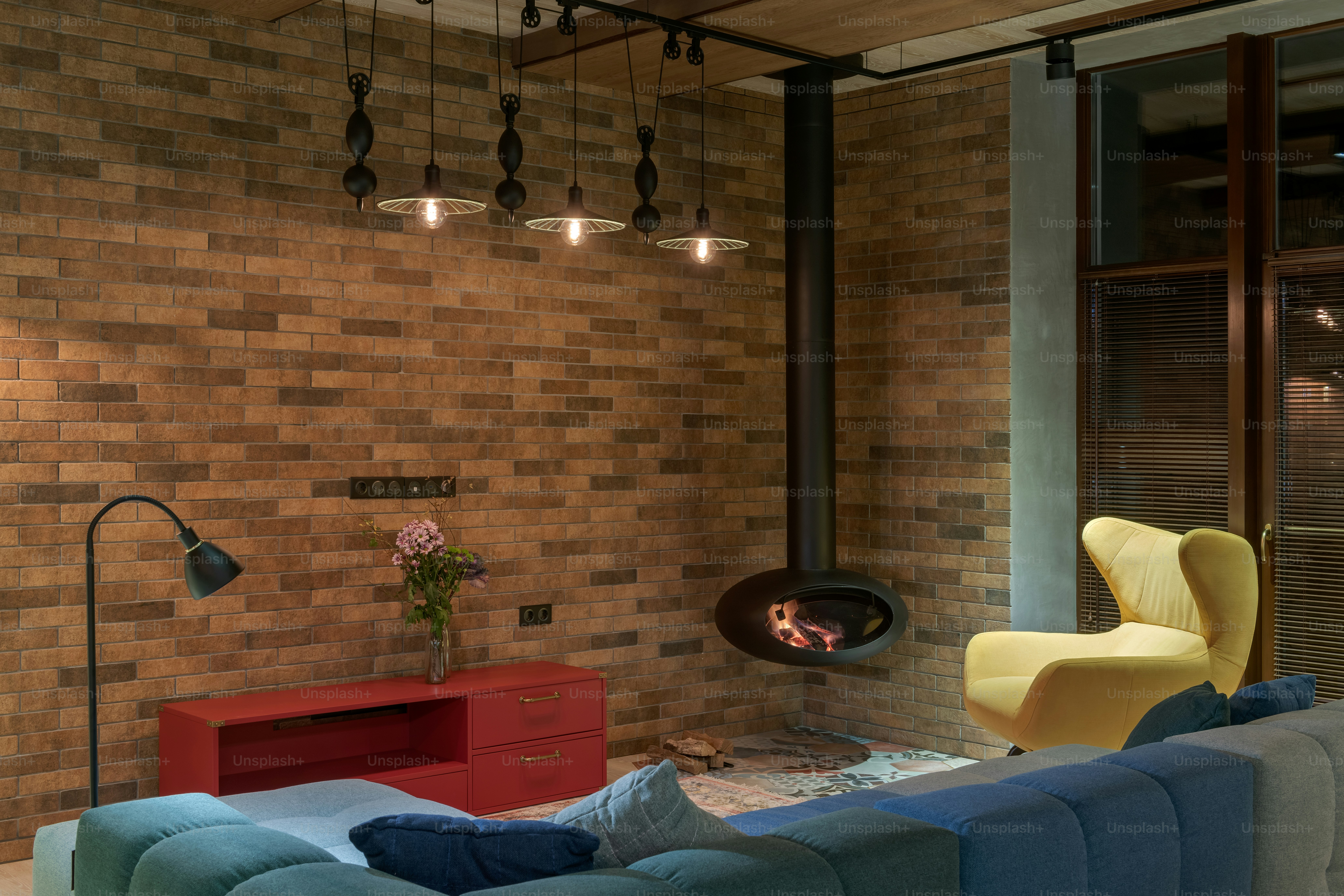 a living room with a blue couch and a fire place