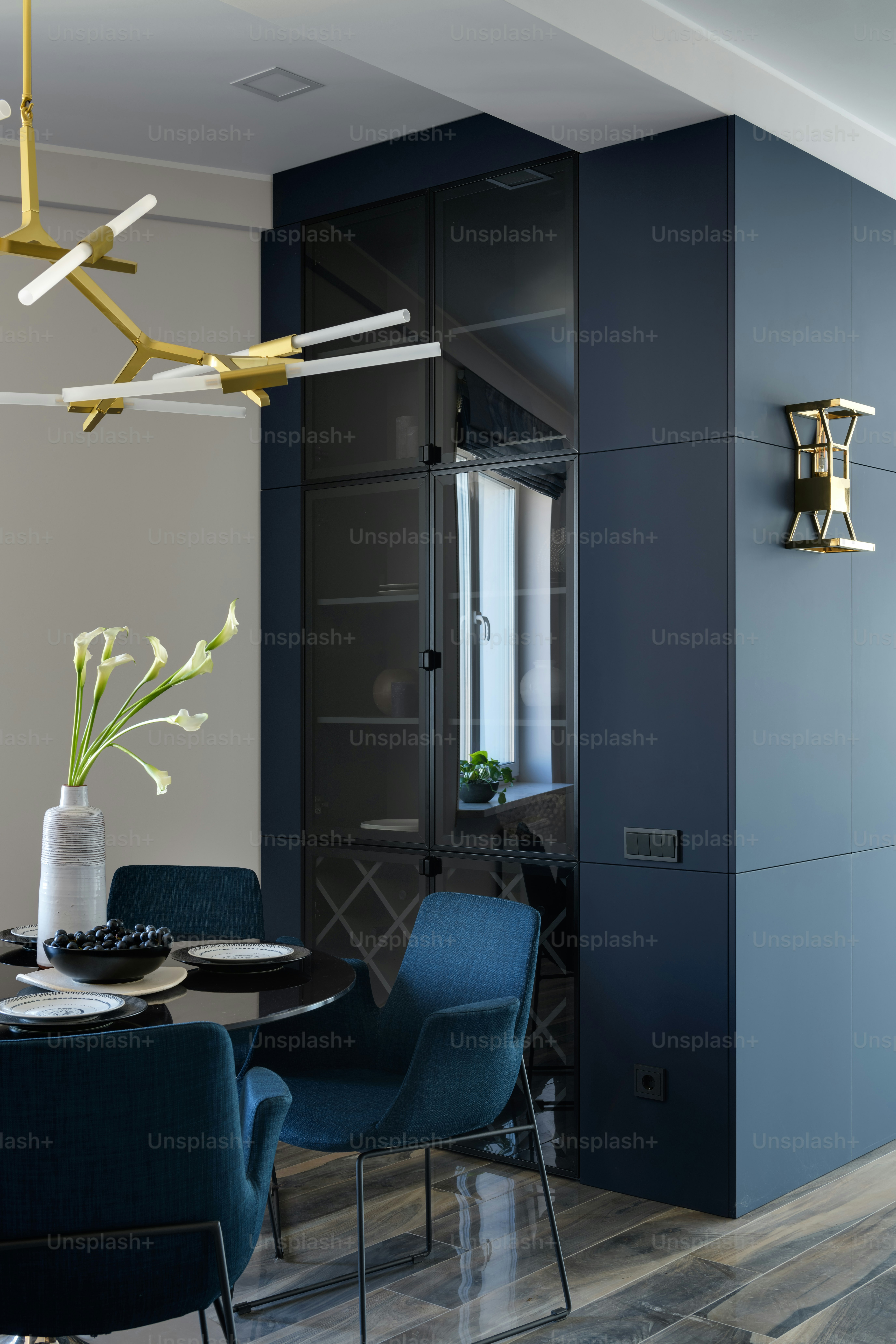 a dining room with blue chairs and a table